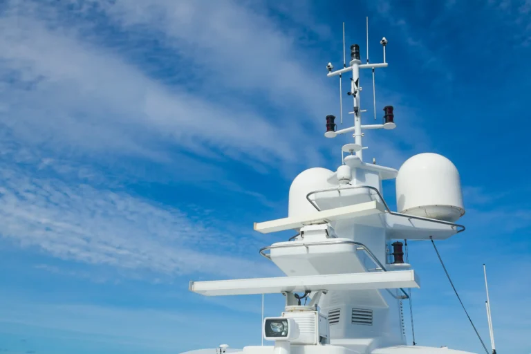 Radar equipment on yacht against blue sky