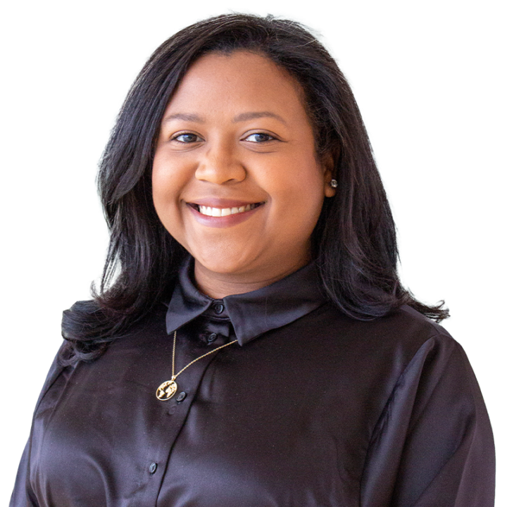 Smiling person wearing black shirt with necklace.