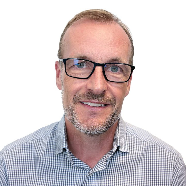 Man with glasses and checkered shirt smiling