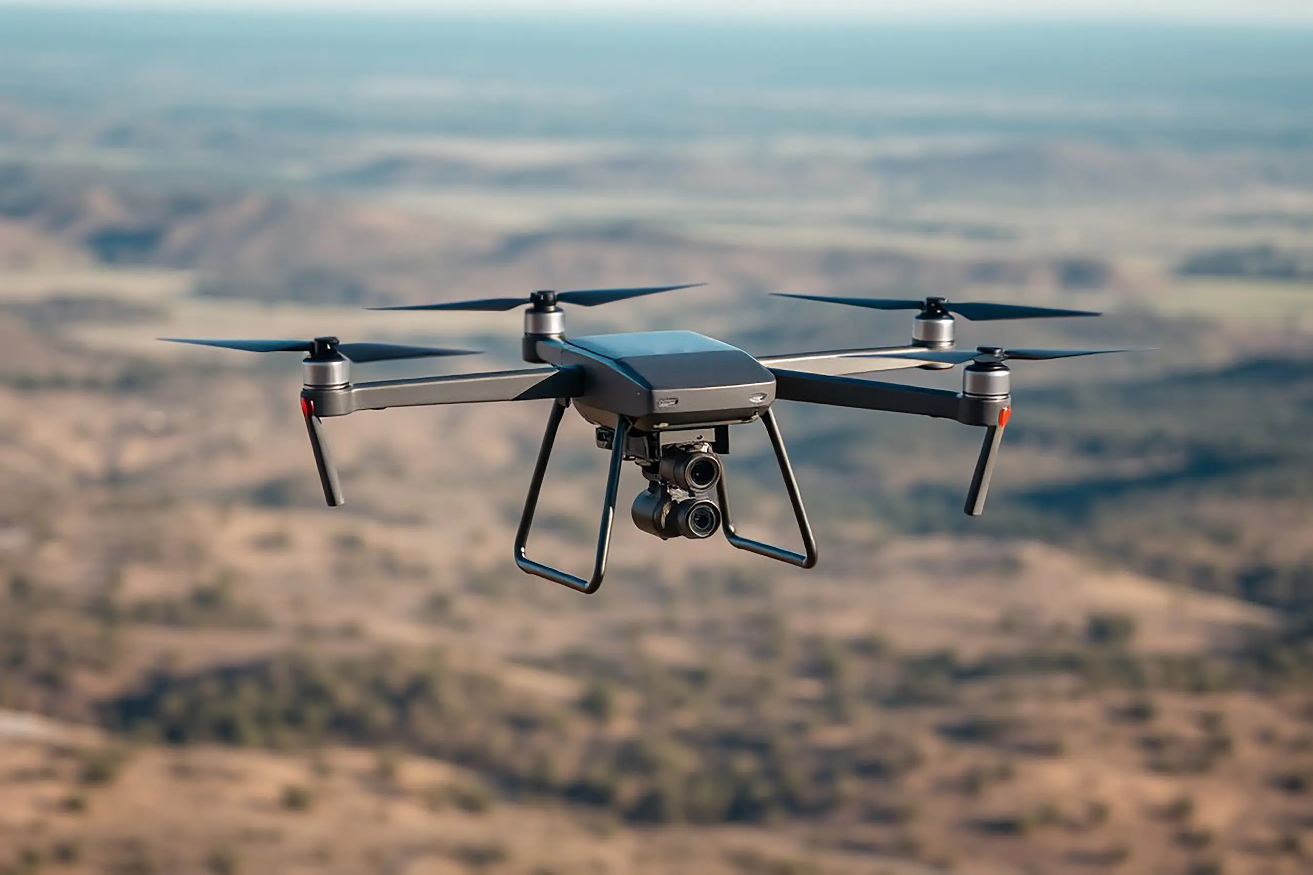 Quadcopter drone flying over blurred landscape